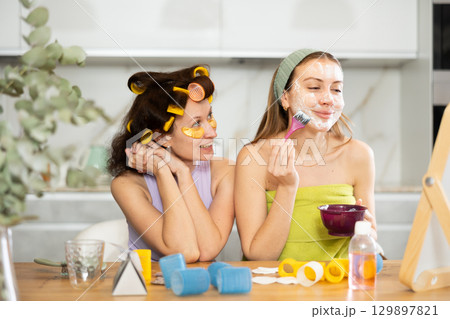 Female friends having pampering day, sharing skincare tips 129897821