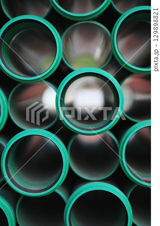 Row of green pipes with a black background 129898821