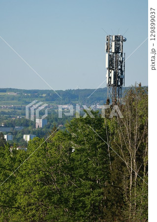 A tall tower with a lot of antennas on top of it A tall tower with a lot of antennas on top of it 129899037