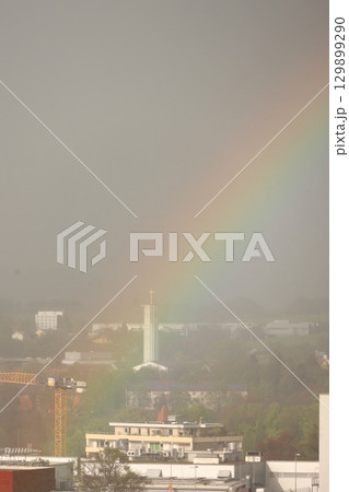 A rainbow is seen in the sky above a city A rainbow is seen in the sky above a city 129899290