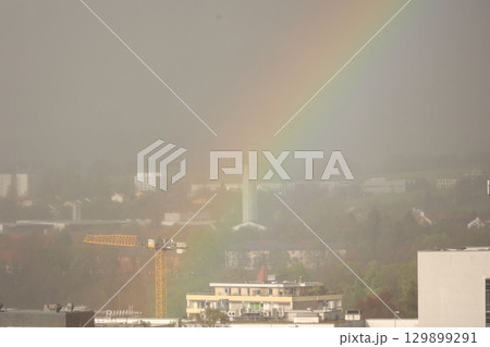 A rainbow is seen in the sky above a city A rainbow is seen in the sky above a city 129899291