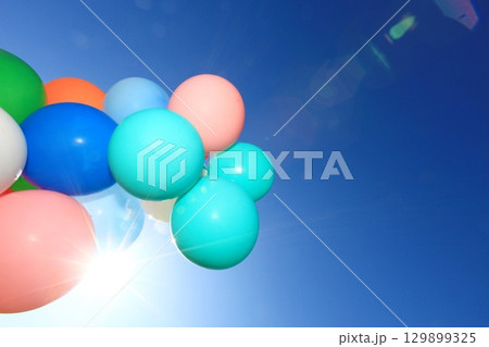 Bunch of colorful balloons floating in the sky 129899325