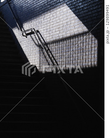 Staircase with a shadow cast on the wall 129899491