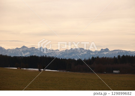 Mountain range is visible in the distance, with a cloudy sky above Mountain range is visible in the distance, with a cloudy sky above 129899682