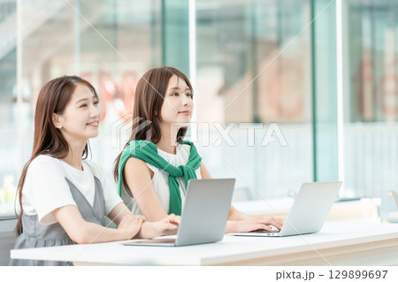 大学の教室でパソコンを操作する大学生 大学の教室でパソコンを操作する大学生 129899697