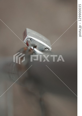 Silver lock is on a metal pole Silver lock is on a metal pole 129900035