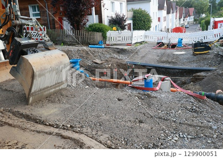 Construction site with a large excavator digging a hole 129900051