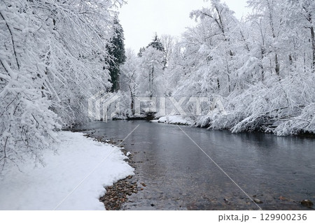 Snowy landscape with a river running through it 129900236