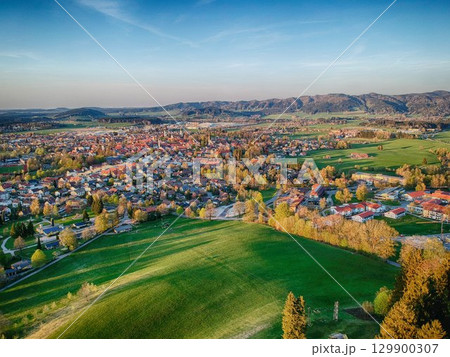 Beautiful, green hillside with a small town below 129900307