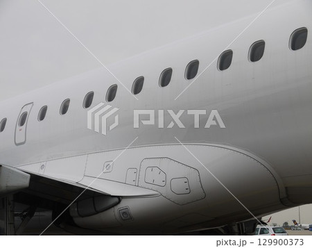 The airplane is white and has a lot of windows 129900373