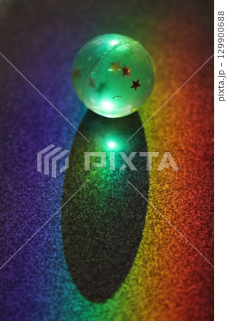 Ball with stars on it is lit up and sitting on a table Ball with stars on it is lit up and sitting on a table 129900688