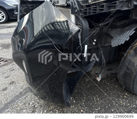 Black car with a smashed front end 129900699