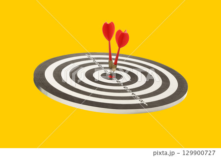 Two red darts hit the target's center Two red darts hit the target's center 129900727
