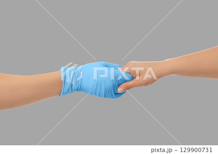 Medical staff offers reassurance through a gentle handhold 129900731
