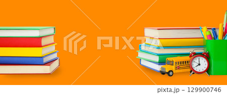 Vibrant stack of books and school supplies for learning 129900746