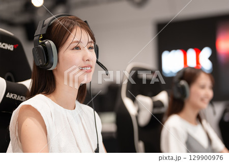 eスポーツの大会でゲームを楽しむ若い女性 129900976