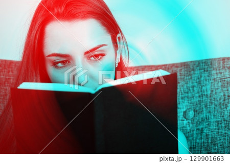Studio portrait of beautiful woman reading book in RGB color split effect style 129901663