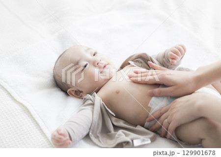 赤ちゃんのお世話をする若い母親　  129901678