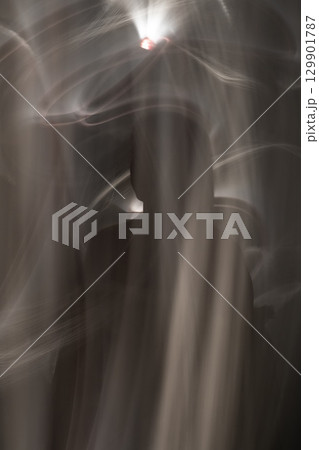 Abstract human silhouette in light trails of light painting 129901787