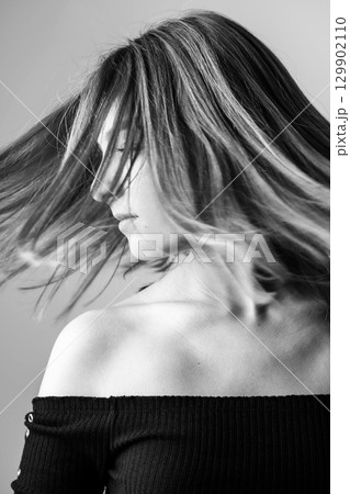 Woman portrait with levitating hairs in air 129902110