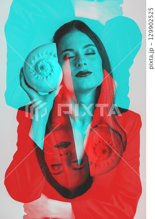 Woman listen sea rustle in seashell near her ear with closed eyes Woman listen sea rustle in seashell near her ear with closed eyes 129902525