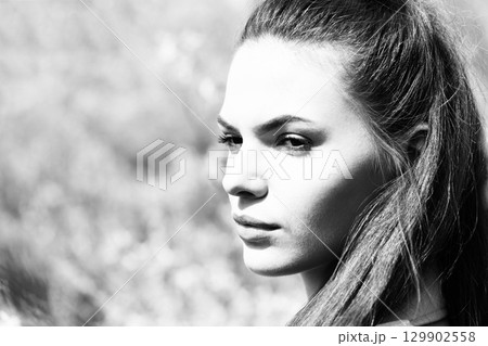 Close-up beautiful woman profile outdoor portrait in nature background 129902558