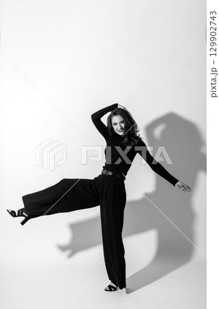 Woman with black outfit studio portrait on white background Woman with black outfit studio portrait on white background 129902743