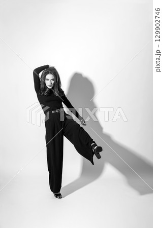 Woman with black outfit studio portrait on white background 129902746