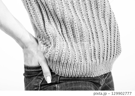 Close-up shot of woman wearing blue sweater and jeans Close-up shot of woman wearing blue sweater and jeans 129902777