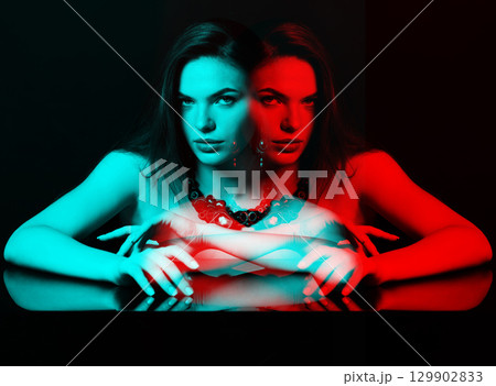 Beautiful woman with fancy necklace and earrings studio portrait in RGB colors split effect 129902833