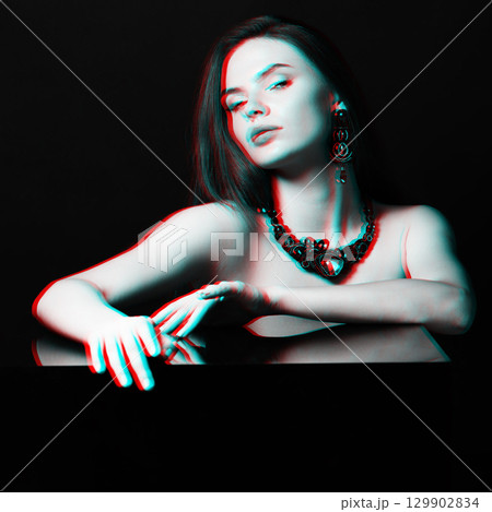 Beautiful woman with fancy necklace and earrings studio portrait in RGB colors split effect Beautiful woman with fancy necklace and earrings studio portrait in RGB colors split effect 129902834
