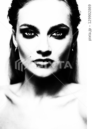 Beautiful woman with smokey make-up close up studio portrait 129902869