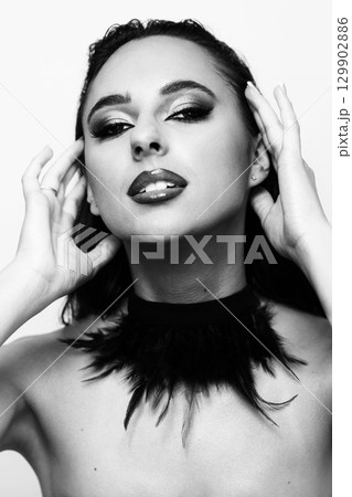 Beautiful woman with smokey make-up and wet hair studio portrait 129902886