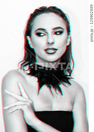 Beautiful woman with smokey make-up close up studio portrait in RGB color split effect 129902889