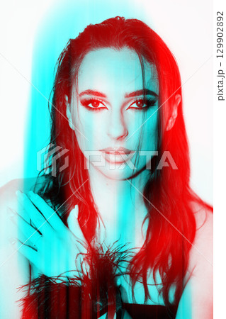 Beautiful woman with smokey make-up close-up studio portrait in RGB color split effect 129902892