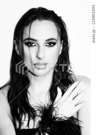 Beautiful woman with smokey make-up and wet hair studio portrait 129902893