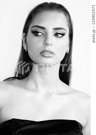 Beautiful woman with smokey makeup close up studio portrait Beautiful woman with smokey makeup close up studio portrait 129902971