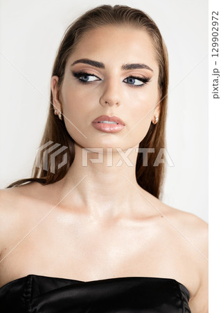 Beautiful woman with smokey make-up close up studio portrait Beautiful woman with smokey make-up close up studio portrait 129902972