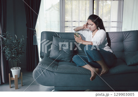 Sorrowful woman sat alone, overwhelmed by emotion, her sad and unhappy expression revealing deep despair, stress and distress left feeling depressed. sorrowful sad, despair alone, depressed stress Sorrowful woman sat alone, overwhelmed by emotion, her sad and unhappy expression revealing deep despair, stress and distress left feeling depressed. sorrowful sad, despair alone, depressed stress 129903005