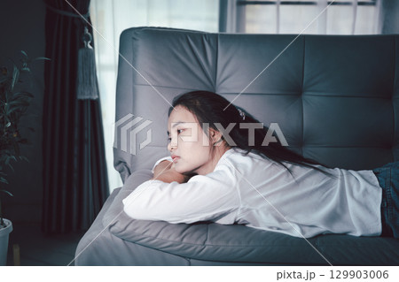 Sorrowful woman sat alone, overwhelmed by emotion, her sad and unhappy expression revealing deep despair, stress and distress left feeling depressed. sorrowful sad, despair alone, depressed stress Sorrowful woman sat alone, overwhelmed by emotion, her sad and unhappy expression revealing deep despair, stress and distress left feeling depressed. sorrowful sad, despair alone, depressed stress 129903006
