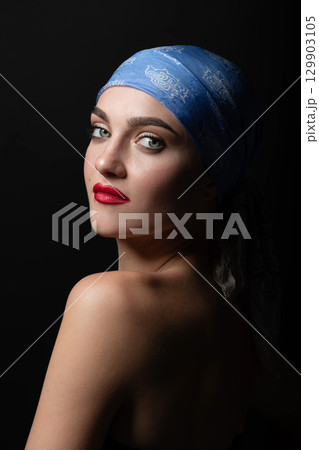 Woman with make-up and scarf on her head studio portrait Woman with make-up and scarf on her head studio portrait 129903105