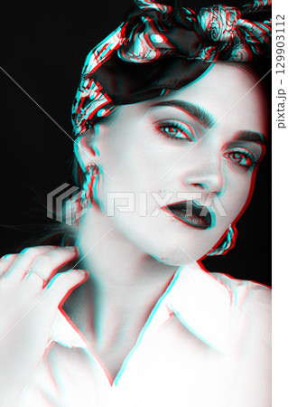 Studio portrait of beautiful woman with scarf on her head touching her neck with hand in rGB color split style 129903112