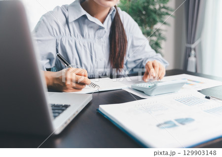 Business woman analyze calculate company financial, tax results office accounting statistics analytical research. calculating business balance prepare tax reduction. Tax deduction planning concept. 129903148