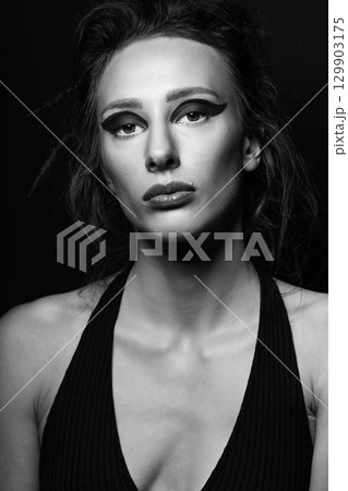 Studio portrait of beautiful woman with eye shadows and dreadlocks 129903175