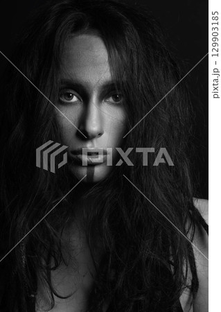 Studio portrait of sexy woman with make-up and hair with dreadlocks Studio portrait of sexy woman with make-up and hair with dreadlocks 129903185