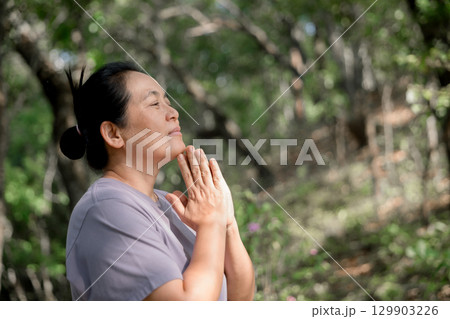 Grateful woman having HOPE praying to God. Spiritual girl smiling to sky. Happy female being thankful. Spiritual girl praying with hope. Positive asian young woman feeling hope and faith looking up. 129903226