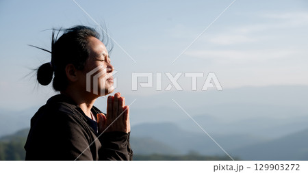 Grateful woman having HOPE praying to God. Spiritual girl smiling to sky. Happy female being thankful. Spiritual girl praying with hope. Positive asian young woman feeling hope and faith looking up. 129903272