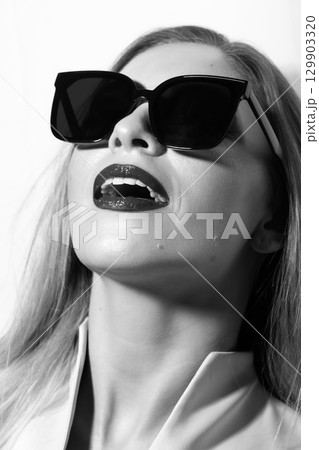 Beautiful woman close-up studio portrait with sunglasses Beautiful woman close-up studio portrait with sunglasses 129903320