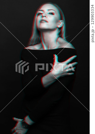Beautiful woman with black dress studio portrait in RGB color split effect style 129903334