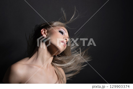 Beautiful woman with flying hair studio portrait Beautiful woman with flying hair studio portrait 129903374